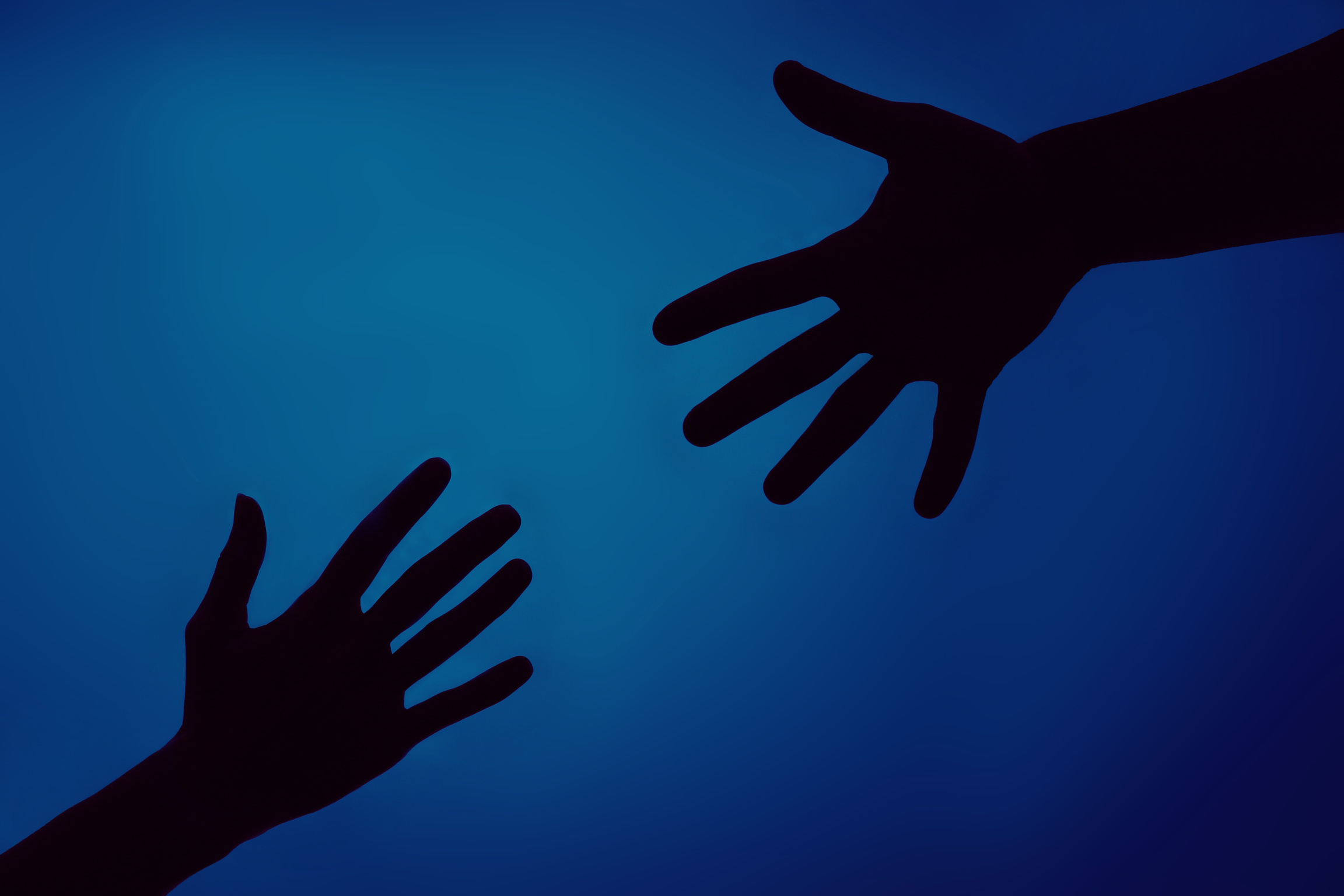 Silhouette of Hands Reaching Out, Closeup